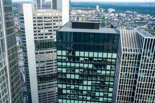 Daytime view of the Frankfurt Germany skyline features a modern glass skyscraper with offices and highrise architecture over the downtown city