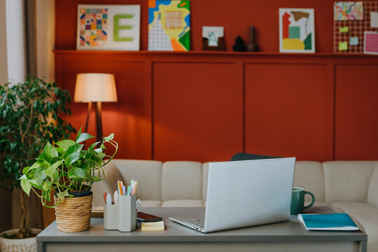 Modern design studio interior with desk and laptop