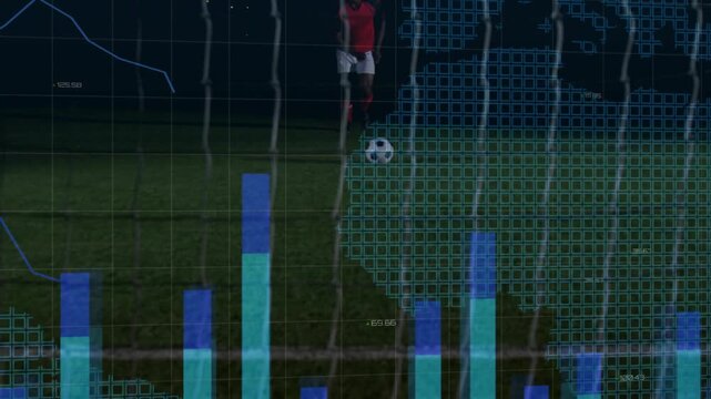 Soccer player starting run and kicking ball through net on night pitch, analytics tracking shot