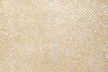 Fototapeta premium Soft gold mesh texture with glitter bokeh background and woven fabric pattern, close-up