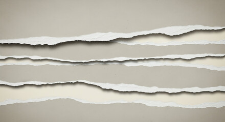 Fototapeta premium Close-up of torn paper edges revealing layered textures and shadows.