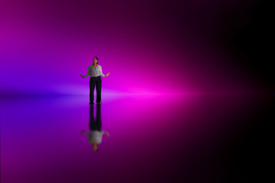 Woman standing magenta gradient scene with reflective studio floor.
