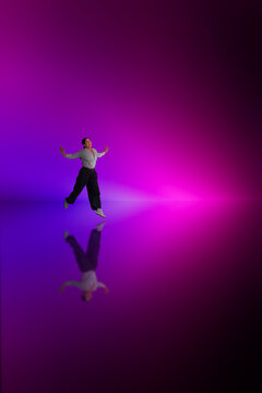 Woman running purple glow scene with mirrored floor reflection