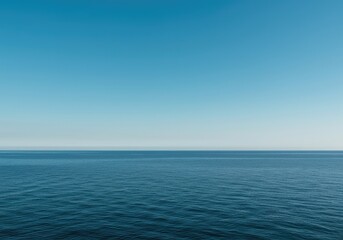 Obraz premium A vast, simple scene showing the meeting point of the calm, deep ocean and the clear, expansive blue sky, creating an ideal minimalist background, pure, expansive, quiet