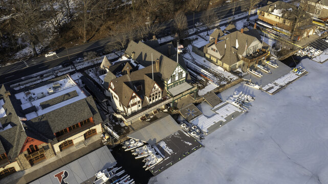 Aerial view of the historic Boathouse Row reflecting on the Schuylkill River's icy surface, contrasting with the vibrant architecture, Philadelphia, Pennsylvania, United States.
