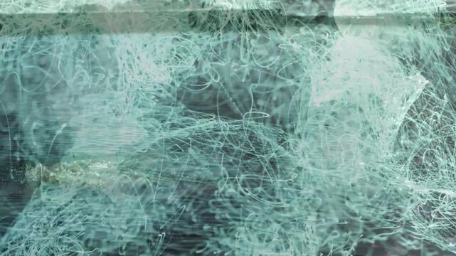 Woman waist-deep in coastal water, teal-blue particles appearing, splashes producing reactive VFX