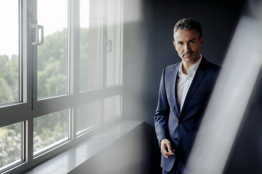 Portrait of confident businessman at the window