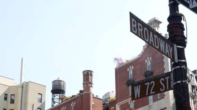 New York City Broadway street sign on Manhattan, United States. Urban road sign in american city. Traffic sign in Midtown of NYC, USA. Red building architecture in West side district, 72 street corner