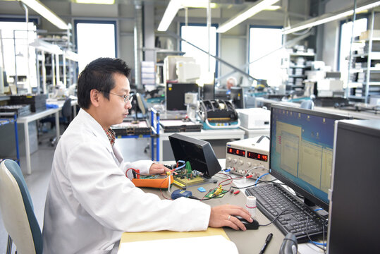 asian engineer at work - electronics assembly and development in a modern factory
