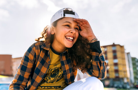 Portrait of laughing girl wearing baseball cap
