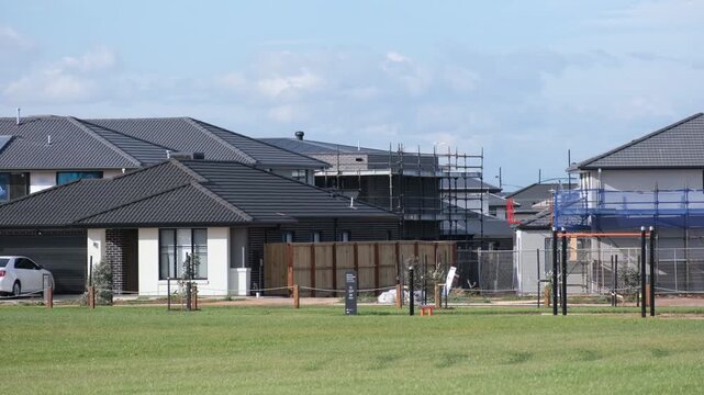 New suburban homes and houses under construction in Aintree, Melbourne, Australia. Modern residential development with scaffolding and newly built houses. Rapid expansion of outer suburban communities