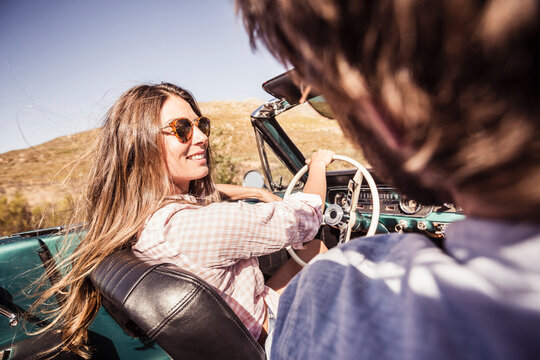 Couple in convertible car on a road trip