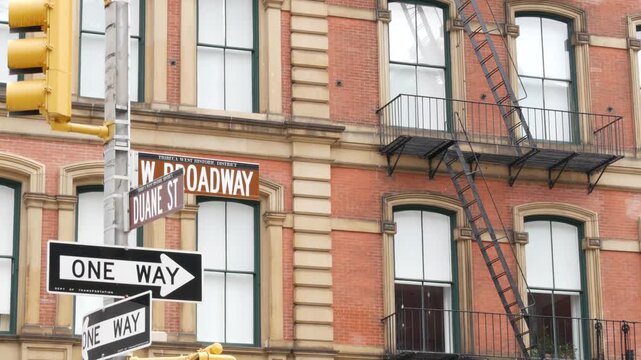 New York City West Broadway and Duane street sign in Lower Manhattan, United States. Urban road sign in american city, traffic sign in NYC. Red brick building architecture, Tribeca district. One way.