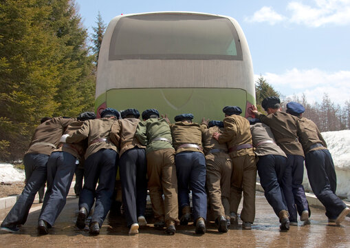 North Korean students pushing a bus out of order, Ryanggang Province, Samjiyon, North Korea