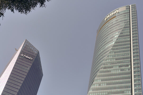 Financial District Growth In Madrid Spain Kpmg And Ohla Skyscrapers Against A Clear Sky Symbolizing Business Expansion And Urban Development