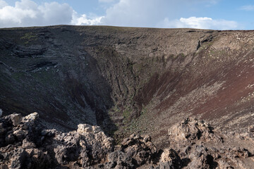View inside Calderon Hondo volcanic crater with lava rocks and rugged slopes in Fuerteventura Canary Islands natural colors © Lune Huit