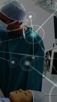 Vertical video: Clinician adjusting hands over patient, activating HUD overlay guiding surgery