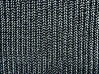 black white ribbed knit fabric macro closeup reveals intricate vertical zigzag yarn texture cozy monochrome pattern