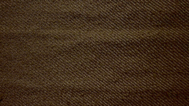 earthy brown twill denim fabric texture macro closeup reveals intricate diagonal weave pattern natural tactile folds