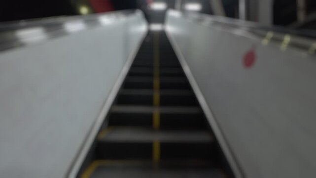 Bokeh view of escalator at Andheri station in Mumbai, India. Blurred background footage.