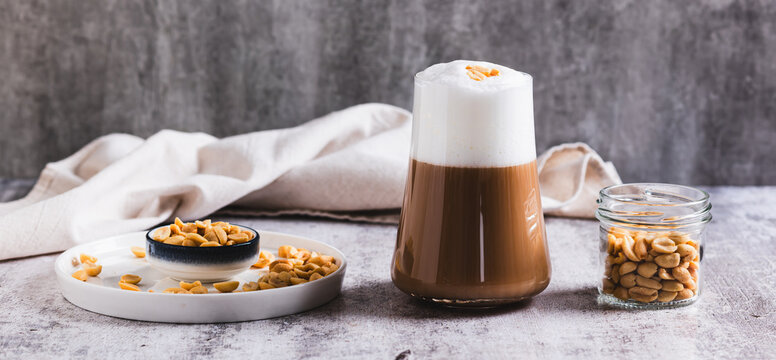 Gourmet peanut raf coffee in a glass on the table web banner