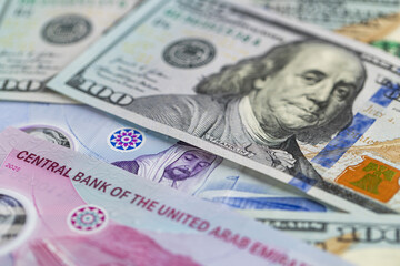 Fototapeta premium International Currency Exchange with US Dollars and United Arab Emirates Dirhams