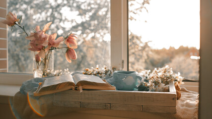 Cozy morning scene with open book, flowers, and coffee cup by the window © shine.graphics