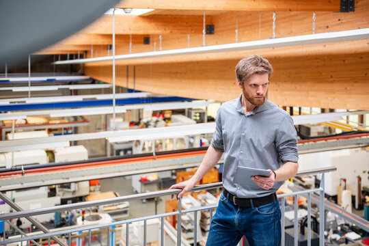 Portrait of manager with tablet in modern industrial facility