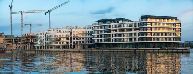 A modern housing estate of multi-story residential buildings by the river