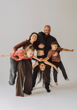 Happy family playing together indoors enjoying joyful childhood