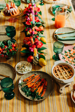 Festive Easter family dinner table with flowers and traditional food