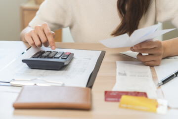 Deduction planning, debt asian young woman calculating money balance of finance from bill and...