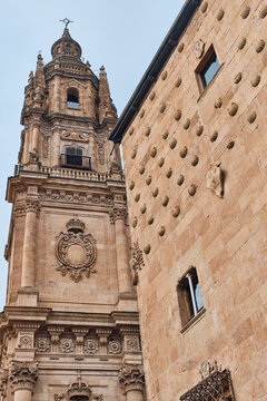 View of intricately carved sandstone buildings stand in contrast, the Casa de las Conchas with its unique shell decorations, Salamanca, Castile and Leon, Spain.