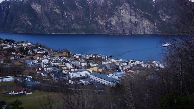 Scenic shot of Stranda, a small town in western Norway surrounded by mountains and fjords on a bright day