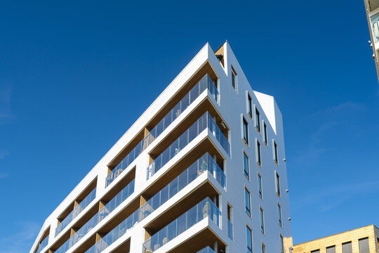 View of a striking white building with sharp angles reaching towards a vibrant blue sky, a modern architectural marvel, Oslo, Oslo, Norway.
