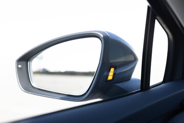 Fototapeta premium System blind spots of the car. Detail of side keeping assist system switch button. Blind zone monitoring sensor on the side mirror of a modern electric car