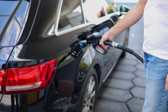 Close Up Of Fuel Nozzle Refueling Modern Car At Gas Station Transportation Energy Concept