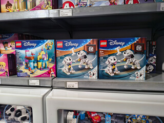 Naklejka premium LEGO Disney toy sets display on store shelf including 101 Dalmatians, Little Mermaid and Cars