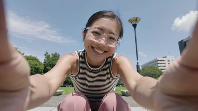 Happy young asian woman with eyeglasses smiling on camera in the city - Urban lifestyle and travel concept - Ugc content - Model by AI generative
