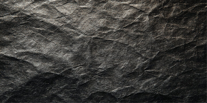 A dark grunge black fabric texture and wrinkled paper surface with a rough crumpled pattern on a vintage gray material background