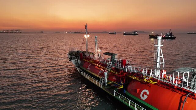 4K LPG tanker ship floating on sea surface during golden sunset