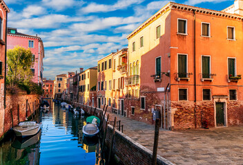 romantic view of a canal in Venice with boats and blue water and beautiful vintage buildings around the cityscape © Yaroslav