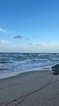 Cinematic view of ocean waves and scenic coastline at Samila Beach during sunset in Songkhla, Thailand.