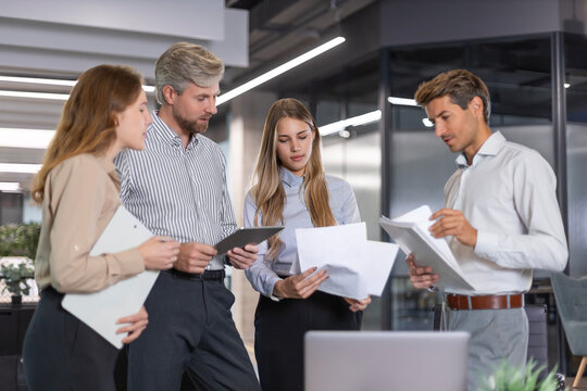 Business team discussing together business plans in office