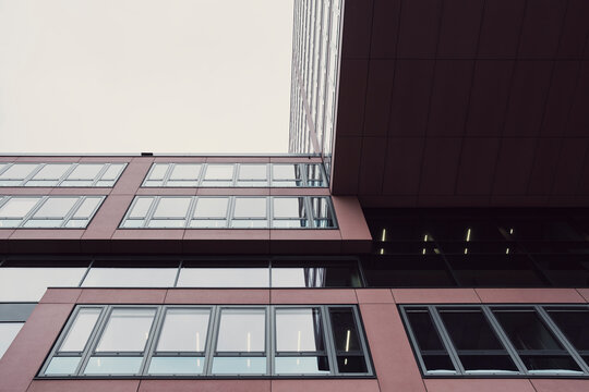 Modern urban building facade with repeating windows and clean lines showing geometry and perspective in exterior architecture detail