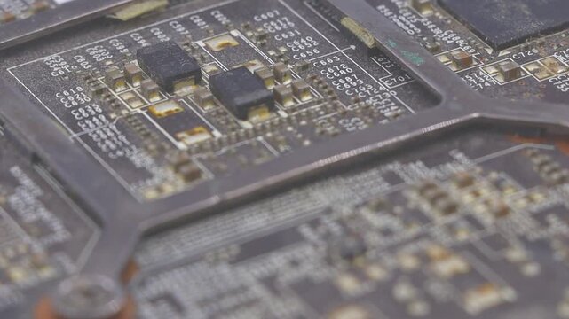 Rotating macro shot of an old computer graphics card. This footage is ideal for technology, obsolescence, or retro computing themes.