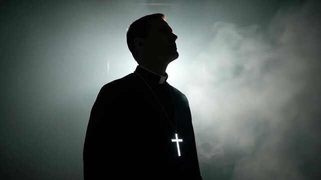 Priest wearing crucifix in smoke. Clergyman standing in dark light during catholic prayer. Devout man silhouette looking heavenward, spiritual belief and faith.