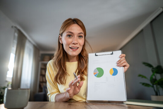 Woman presenting data charts during virtual business meeting