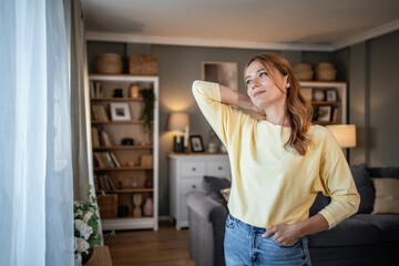 Young woman relaxing at home looking out window