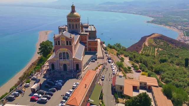 Aerial drone view of the Sanctuary of Tindari in Sicily, overlooking the stunning Mediterranean coast and lagoons. A breathtaking blend of history, faith, and Sicilian landscape from above.
